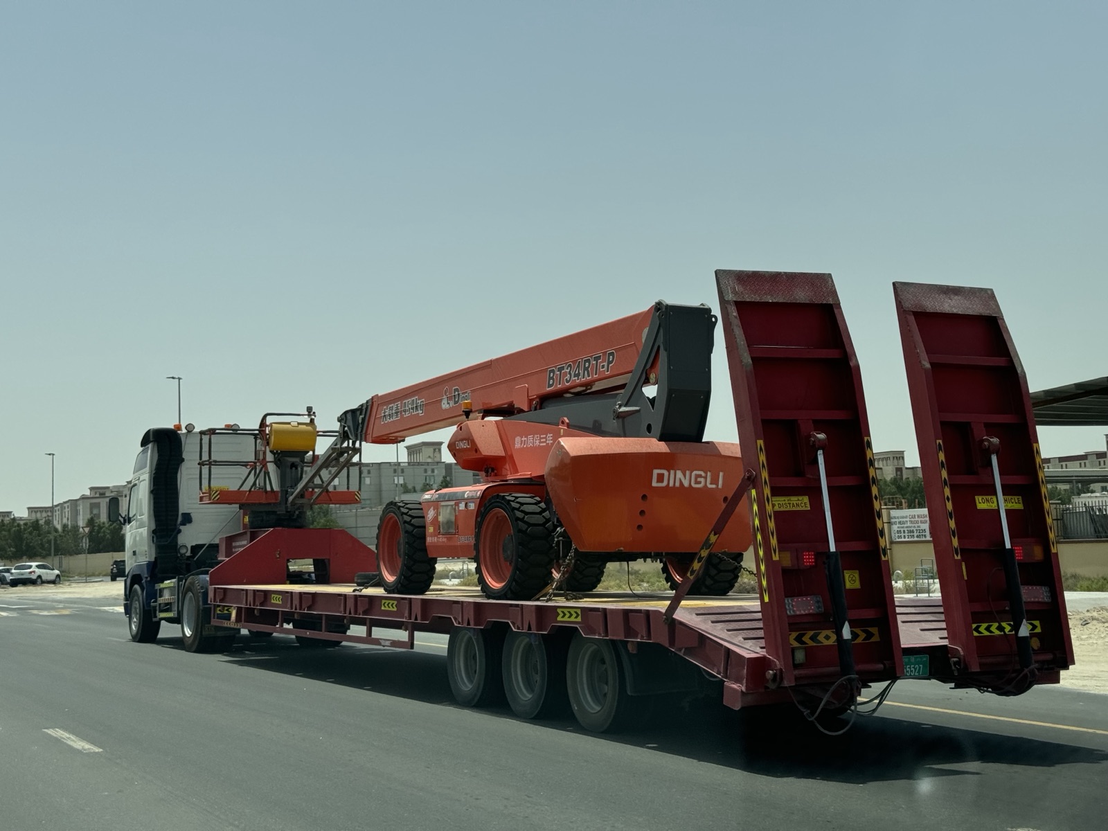 Multi-axle heavy low-bed trailer transporting heavy equipment